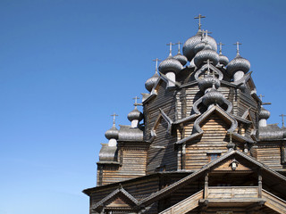Old wooden ortodox cathedral made without nails against blue sky