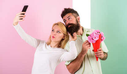 Couple in love bouquet dating celebrate anniversary relations. Sharing happy selfie. Capturing...