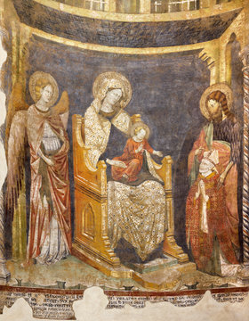 PARMA, ITALY - APRIL 16, 2018: The fresco of Madonna with the child, St. John Baptist and the bishop in Baptistery by "Maestro del 1302".