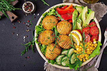 Vegetarian buddha bowl. Raw vegetables and baked potatoes in  bowl. Vegan meal. Healthy and detox food concept. Top view. Flat lay