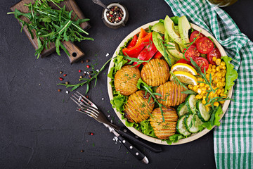 Obraz na płótnie Canvas Vegetarian buddha bowl. Raw vegetables and baked potatoes in bowl. Vegan meal. Healthy and detox food concept. Top view. Flat lay