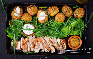 Chicken fillet cooked on a grill with a garnish of baked potatoes. Dietary meal. Healthy food. Top view. Flat lay