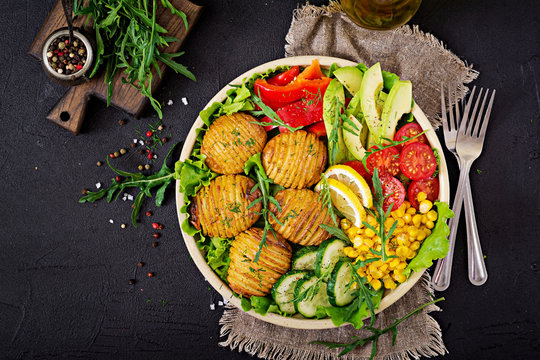 Vegetarian buddha bowl. Raw vegetables and baked potatoes in  bowl. Vegan meal. Healthy and detox food concept. Top view. Flat lay