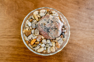 Bowl of rocks sits on a tabletop.