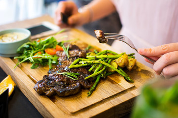 Female having a steak in the restaurant
