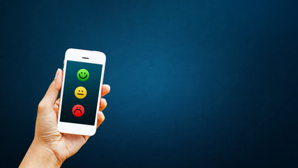 Hand of client select satisfaction on smart phone. Service rating, satisfaction, customer experience concept