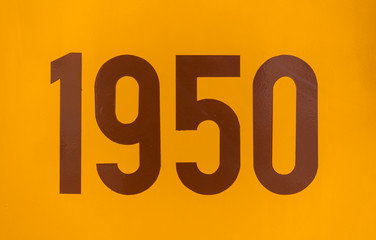 Number 1950 painted in brown on an old orange tram