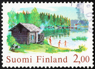 Finnish family having fun outdoor on postage stamp