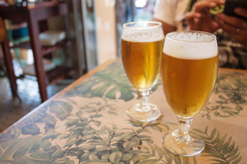 Two glasses of beer on the table in bar