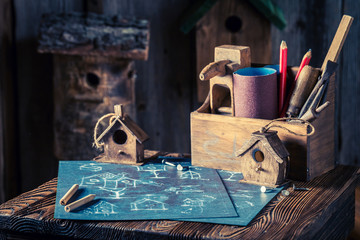 Vintage small bird feeder and blue construction plan