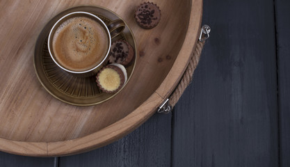 Delicious milk chocolate and morning aromatic coffee. A wooden tray, free space for text.