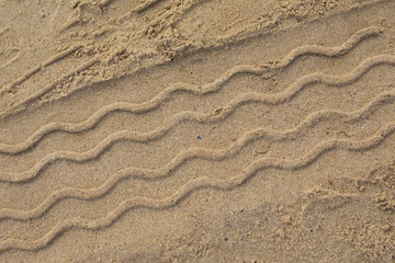 Driving on a sandy beach: tracks left behind