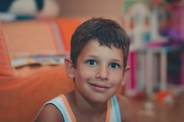 Portrait of a boy with blue eyes looking surprised