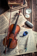 Vintage violin, sheets and ink with feather
