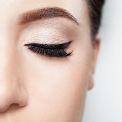 daily make-up with powdery shadows and black hands, long curling black, ennobled eyelashes.