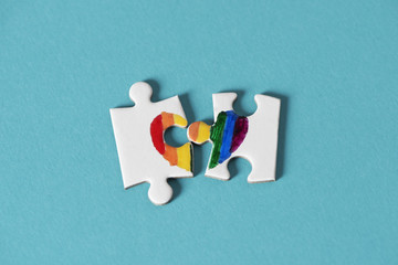 puzzle pieces about to form a rainbow heart.