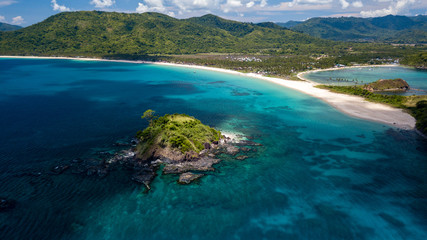 Aerial drone view of beautiful tropical beaches, small islands and surrounding coral reef (Nacpan Beach)