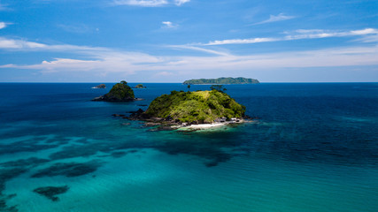 Aerial drone view of beautiful tropical islands surrounded by coral reef © whitcomberd