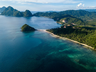Aerial drone view of a tropical ocean with towering limestone islands (El Nido, Palawan)