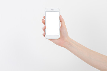 Hand holding white phone isolated on white clipping path inside. Top view.Mock up.Copy space.Template.Blank.
