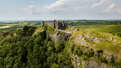 Fototapeta na wymiar Aerial view of the ruins of an ancient castle on a hilltop (Carreg Cennen, Wales, Britain)