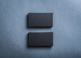 Two stacks of black blank business cards. Mockup for branding identity.