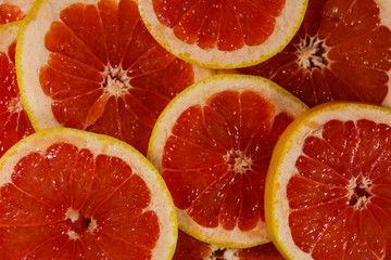 Fresh slices of grapefruits as background