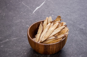 Chinese herbal medicines -- Astragalus on stone background, blank for text, copy space