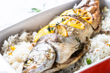 Fish seabass baked with rice and vegetables.