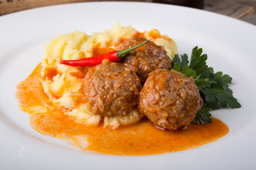 Meatballs served with mashed potato