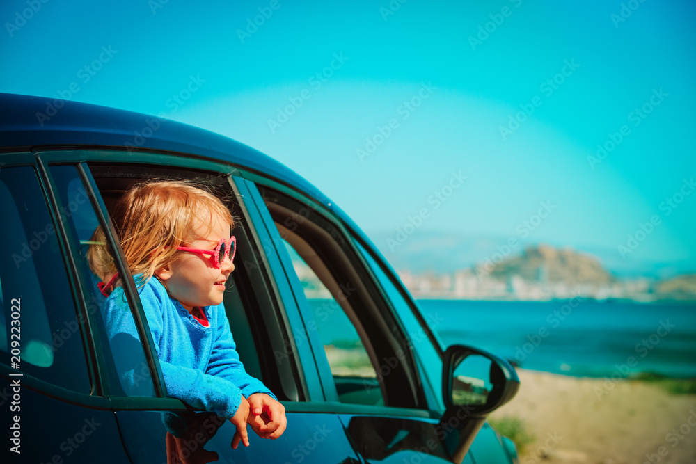 Wall mural happy little girl enjoy travel by car at beach