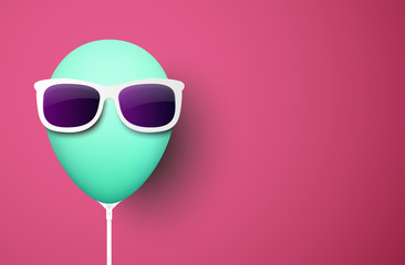 Pink background with green balloon in sunglasses.
