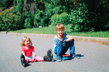 Fototapeta premium happy kids on roller skates and skateboard outside