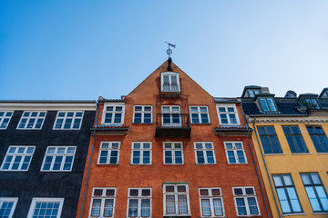 Fototapeta na wymiar low angle view of beautiful colorful houses against blue sky, copenhagen, denmark