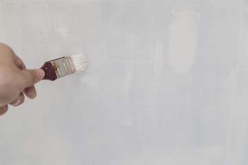 Painting of walls in a white color. Repair in a house.