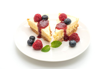 Homemade cheesecake with raspberries and blueberries on white background