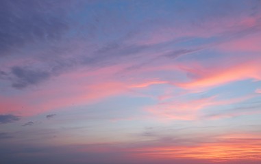 Naklejka na ściany i meble Beautiful pink sunset on blue sky background 