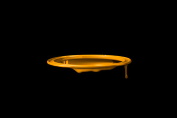 Orange paint leaking over the wall of empty metal bucket