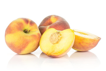 Fototapeta na wymiar Two yellow peaches with one cut in half isolated on white background.