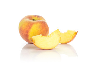 One yellow peach and two sliced pieces isolated on white background.