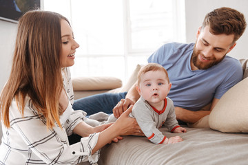 Obraz premium Cute young family. Parents having fun with their little child