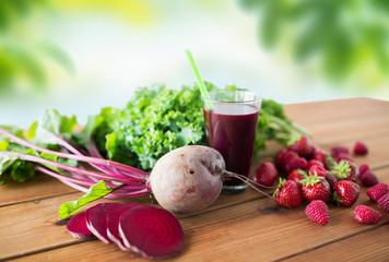 healthy eating, food, dieting and vegetarian concept - glass of beetroot juice, fruits and...