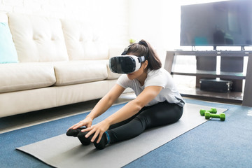 Woman learning yoga poses through virtual reality