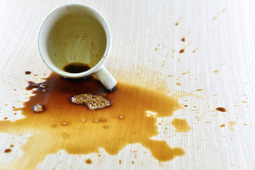 Spilled coffee cup stain on wooden floor