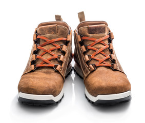 Pair of new brown leather waterproof sneakers isolated on white background. Orange shoelace.
