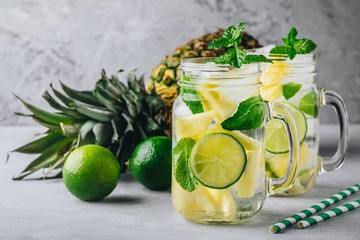 Infused detox water with pineapple, lime and mint. Ice cold summer cocktail or lemonade