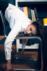 Lady sleeping on back of chair. Close portrait of beautiful office lady wearing white button up...