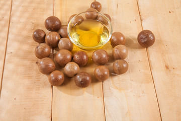 Macadamia nuts on wooden table (Macadamia integrifolia)