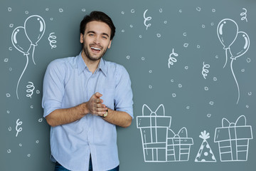 Funny party. Cheerful emotional man enjoying a lovely party and clapping his hands while laughing...