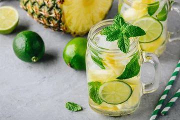 Poster Infused detox water with pineapple, lime and mint. Ice cold summer cocktail or lemonade © nblxer